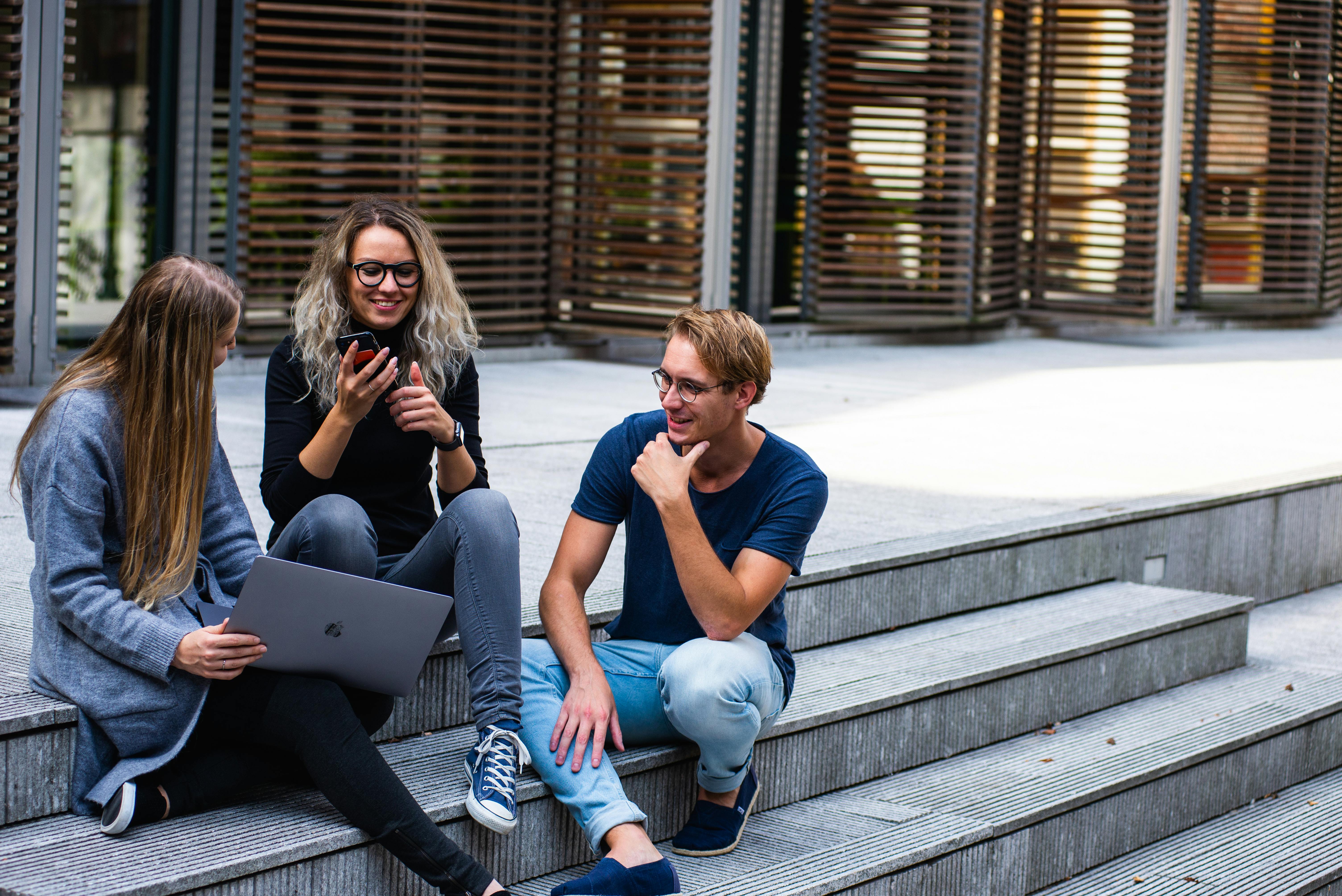 a group of students sitting on the stairs
