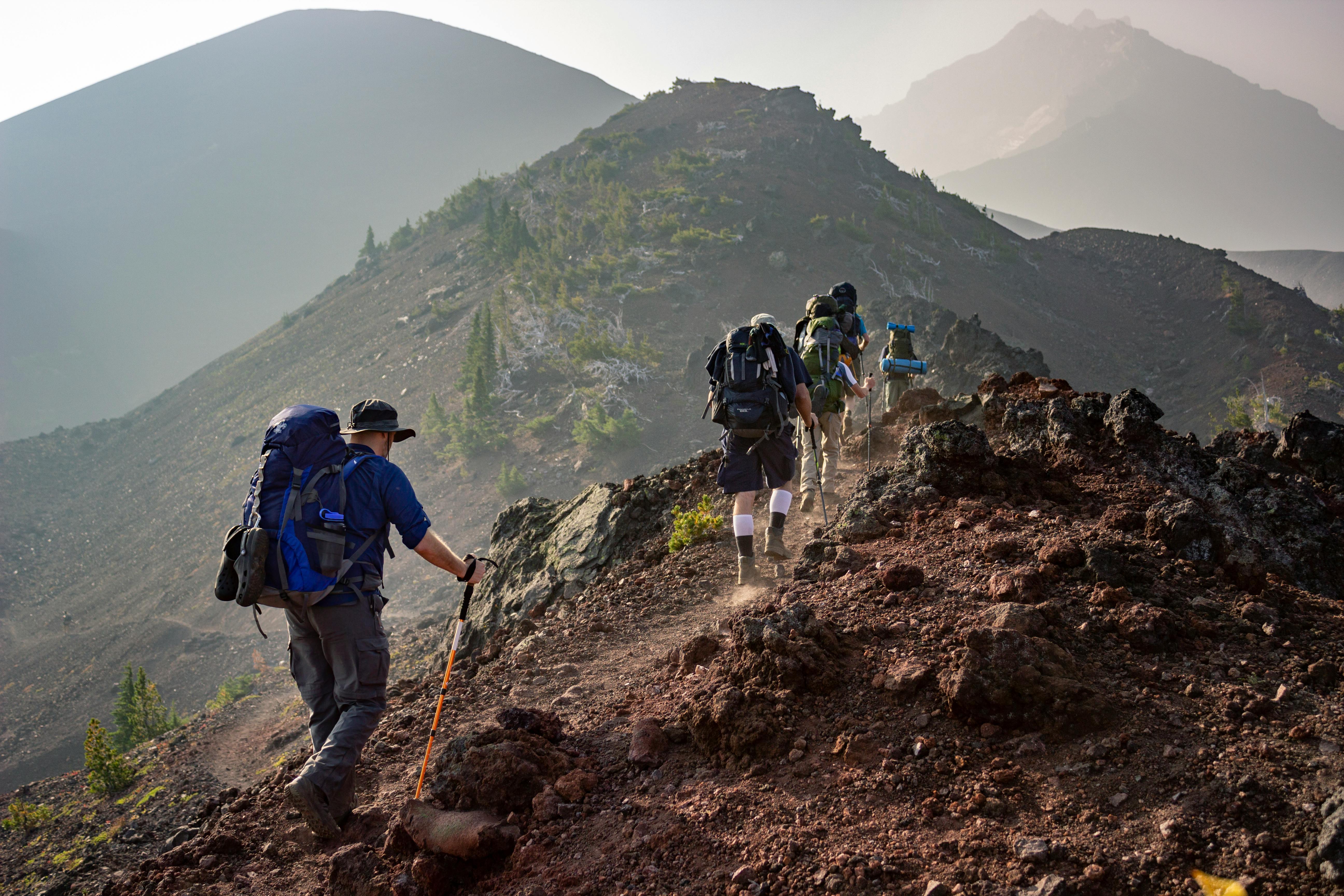 a group of people hiking in the mountains